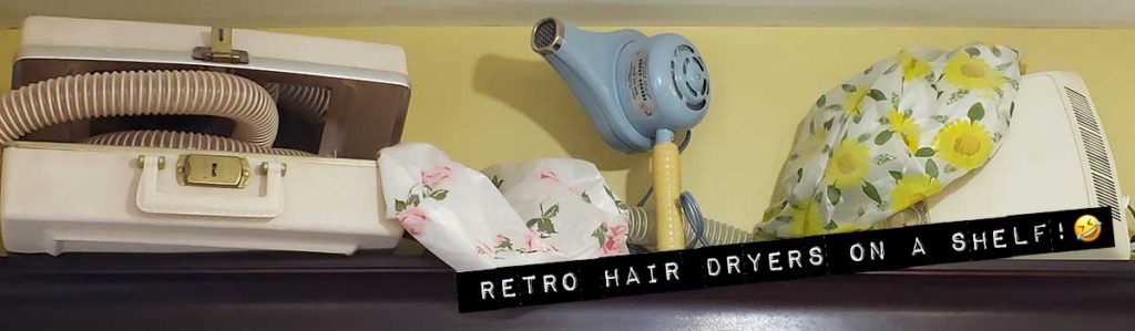 Some retro hair dryers on a shelf